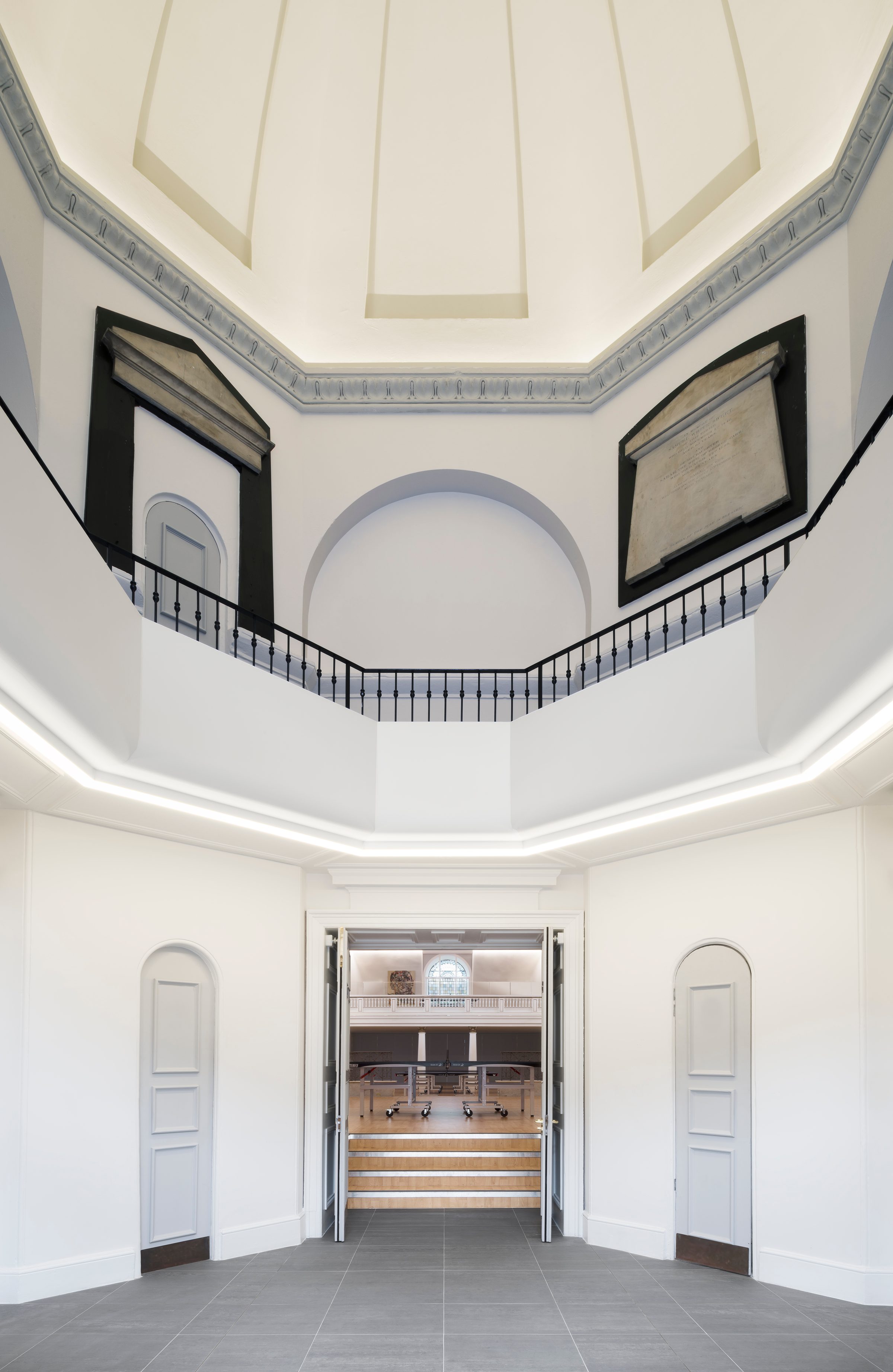 Entrance vestibule beneath the octagonal dome, with memorial tablets and a view through into the hall